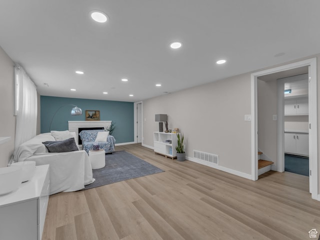 4363 S Butternut Rd E, Holladay, UT 84124 - living room featuring a brick fireplace, light wood-style flooring, recessed lighting, baseboards, and visible vents