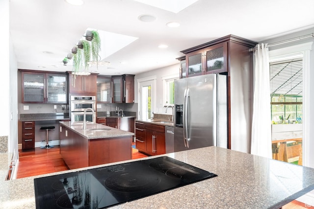 1340 E Oakmont Ln, Fruit Heights, UT 84037 - kitchen with recessed lighting, stainless steel appliances, an island with sink, and a sink