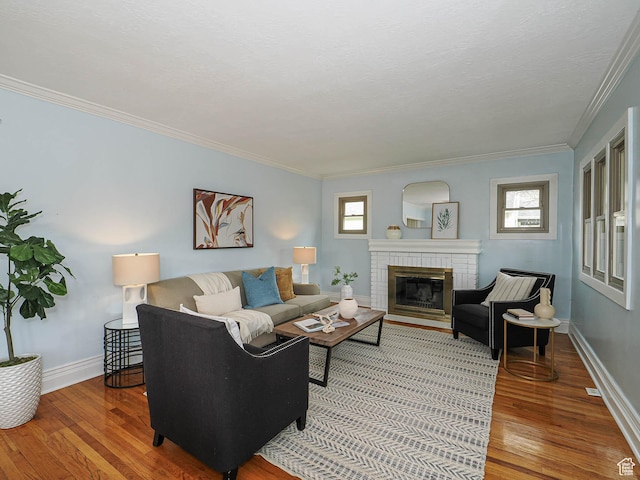 1453 E Vine St S, Murray, UT 84121 - living area featuring light wood-type flooring, baseboards, crown molding, and a fireplace