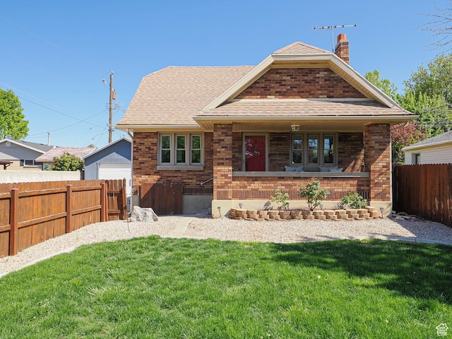 1453 E Vine St S, Murray, UT 84121 - back of house featuring a fenced backyard, roof with shingles, a chimney, brick siding, and a yard