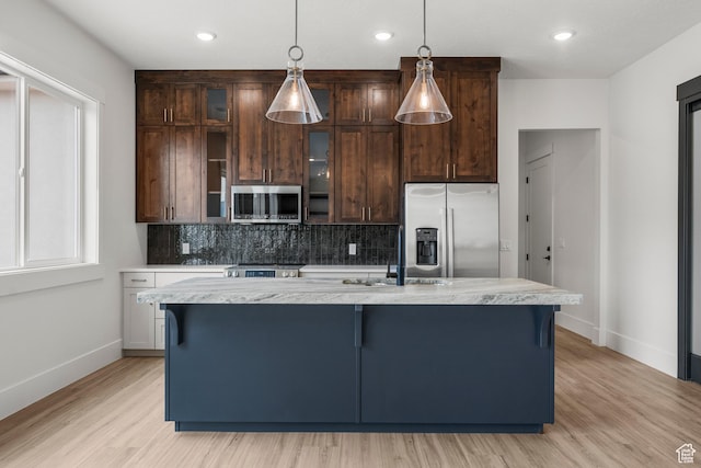 2316 S 2925 W, Cedar City, UT 84720 - kitchen with backsplash, a center island with sink, a sink, baseboards, and stainless steel appliances