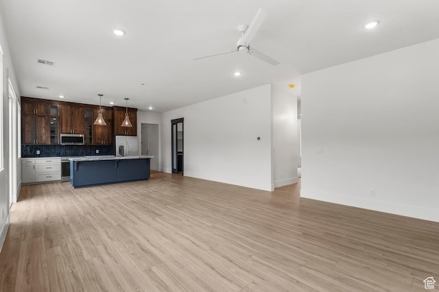 2316 S 2925 W, Cedar City, UT 84720 - unfurnished living room with light wood finished floors, a ceiling fan, and recessed lighting