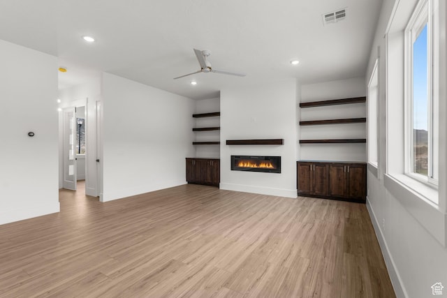 2316 S 2925 W, Cedar City, UT 84720 - unfurnished living room with ceiling fan, visible vents, light wood-type flooring, a glass covered fireplace, and recessed lighting