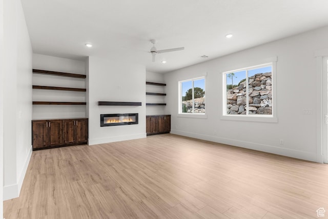 2316 S 2925 W, Cedar City, UT 84720 - unfurnished living room featuring light wood-style floors, ceiling fan, baseboards, a glass covered fireplace, and recessed lighting