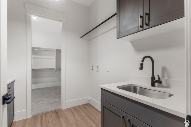 2316 S 2925 W, Cedar City, UT 84720 - washroom featuring light wood-style floors, baseboards, cabinet space, a sink, and washer hookup