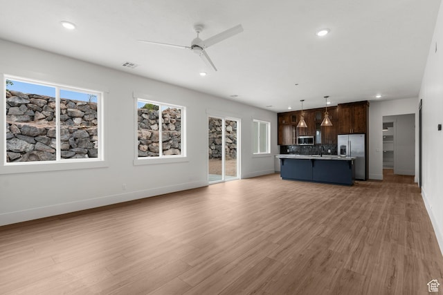 2316 S 2925 W, Cedar City, UT 84720 - unfurnished living room with visible vents, a sink, baseboards, recessed lighting, and a ceiling fan