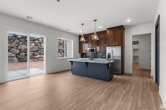 2316 S 2925 W, Cedar City, UT 84720 - kitchen with appliances with stainless steel finishes, a kitchen breakfast bar, baseboards, and dark brown cabinets
