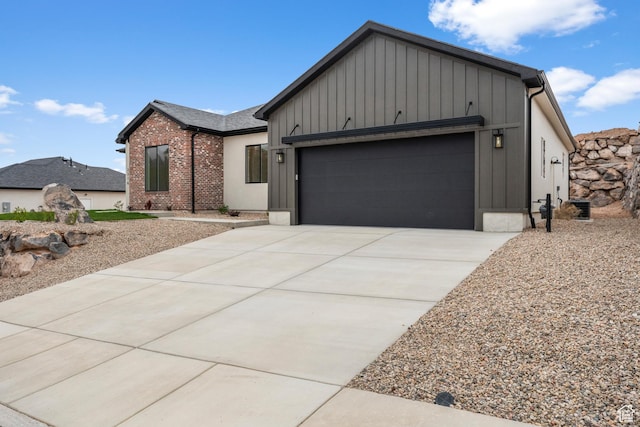 2316 S 2925 W, Cedar City, UT 84720 - view of front facade with brick siding, a garage, board and batten siding, and concrete driveway