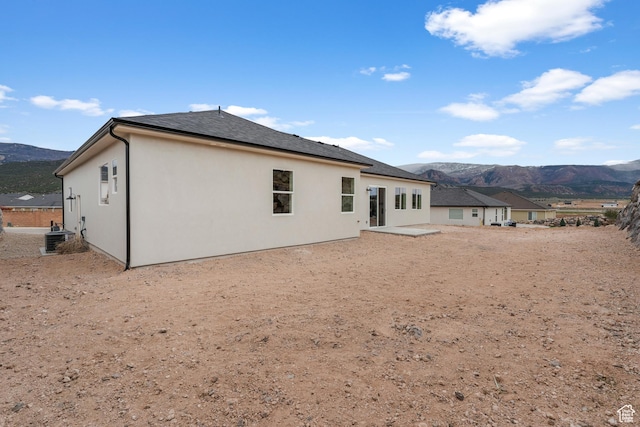2316 S 2925 W, Cedar City, UT 84720 - rear view of property featuring central air condition unit, a mountain view, stucco siding, and a patio area
