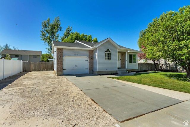 ranch-style home featuring fence, an attached garage, brick siding, a front yard, and driveway