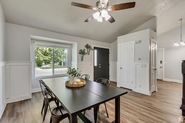 1235 W 1870 N, Lehi, UT 84043 - dining area with vaulted ceiling, a wainscoted wall, ceiling fan with notable chandelier, light wood finished floors, and a decorative wall