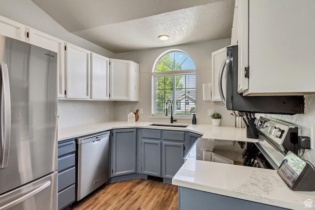 1235 W 1870 N, Lehi, UT 84043 - kitchen featuring a sink, appliances with stainless steel finishes, light wood-type flooring, and white cabinetry
