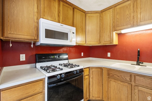 1474 S 430 W Unit 23, Orem, UT 84058 - kitchen with brown cabinets, a sink, light countertops, gas range, and white microwave