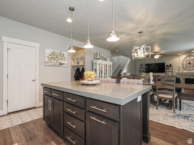 10953 S Kelso Dune Dr, South Jordan, UT 84009 - kitchen with light countertops, open floor plan, dark brown cabinetry, and dark wood-type flooring