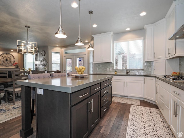 10953 S Kelso Dune Dr, South Jordan, UT 84009 - kitchen with a sink, white cabinetry, dark wood finished floors, and a kitchen bar