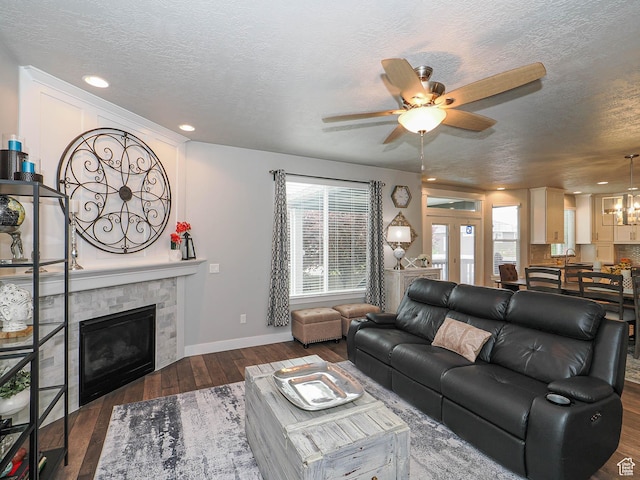 10953 S Kelso Dune Dr, South Jordan, UT 84009 - living area with wood-type flooring, ceiling fan with notable chandelier, a textured ceiling, and a tile fireplace