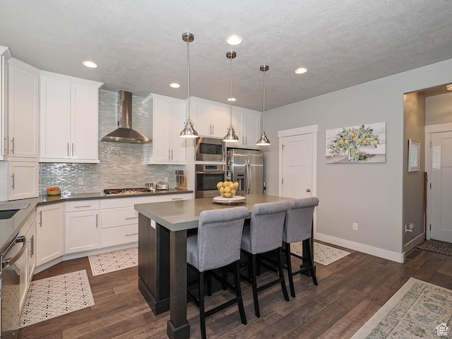 10953 S Kelso Dune Dr, South Jordan, UT 84009 - kitchen featuring wall chimney range hood, appliances with stainless steel finishes, baseboards, and white cabinetry