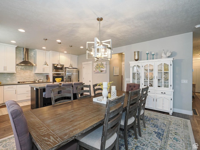 10953 S Kelso Dune Dr, South Jordan, UT 84009 - dining space with recessed lighting, baseboards, an inviting chandelier, and wood finished floors
