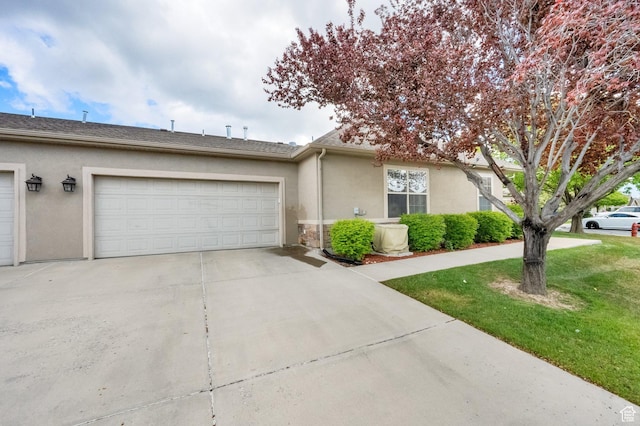 6953 S Country Home Ln W, West Jordan, UT 84084 - view of front of house with concrete driveway, an attached garage, a front yard, and stucco siding