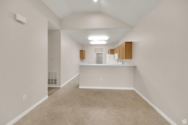 6953 S Country Home Ln W, West Jordan, UT 84084 - kitchen featuring brown cabinets, light countertops, freestanding refrigerator, a peninsula, and visible vents