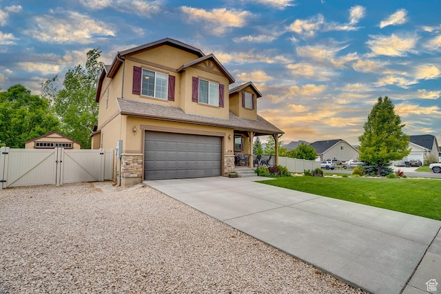 2130 S 450 E, Heber City, UT 84032 - view of front of house featuring a gate, a front lawn, concrete driveway, an attached garage, and stucco siding