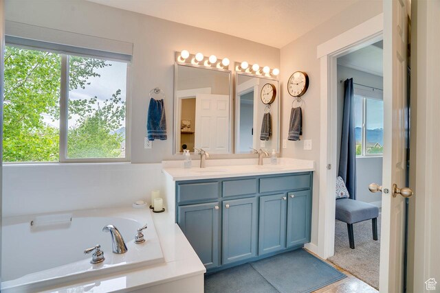 2130 S 450 E, Heber City, UT 84032 - full bath with double vanity, a sink, a healthy amount of sunlight, and a garden tub