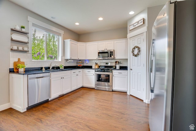2130 S 450 E, Heber City, UT 84032 - kitchen featuring appliances with stainless steel finishes, dark countertops, tasteful backsplash, a sink, and white cabinets