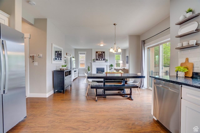 2130 S 450 E, Heber City, UT 84032 - interior space with a healthy amount of sunlight, stainless steel appliances, wood finished floors, and white cabinetry