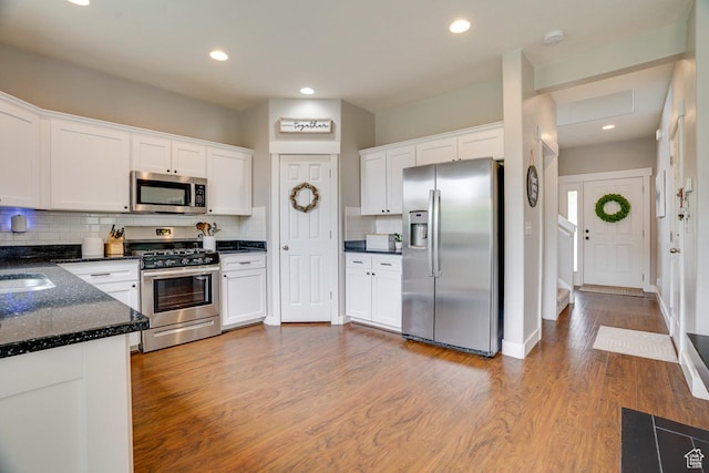 2130 S 450 E, Heber City, UT 84032 - kitchen with backsplash, white cabinetry, appliances with stainless steel finishes, and wood finished floors