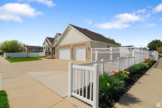 2295 E 2150 N, Layton, UT 84040 - view of side of property with brick siding, driveway, fence private yard, and a garage