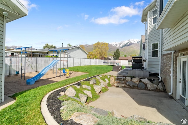 2295 E 2150 N, Layton, UT 84040 - view of yard with a patio area, a fenced backyard, a playground, and a mountain view