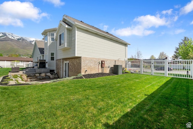 2295 E 2150 N, Layton, UT 84040 - view of side of home with a yard, brick siding, fence, and a mountain view