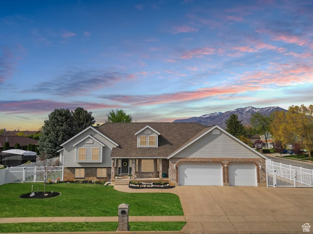 view of front of home featuring driveway, a gate, a garage, brick siding, and a yard