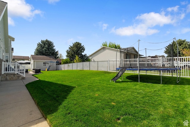 2295 E 2150 N, Layton, UT 84040 - view of yard featuring an outdoor structure, a fenced backyard, a trampoline, and a storage unit