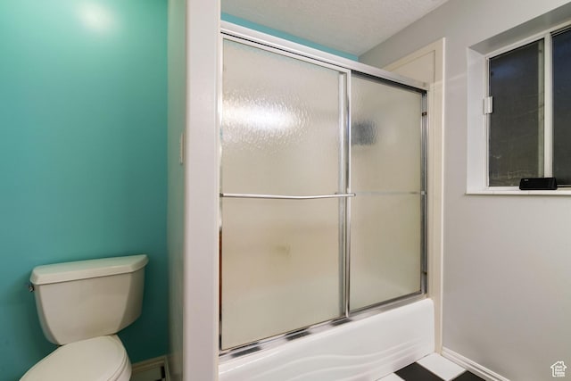 2295 E 2150 N, Layton, UT 84040 - bathroom featuring baseboards, bath / shower combo with glass door, and toilet