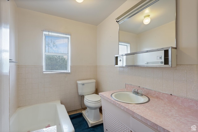 424 S 400 E, Orem, UT 84097 - bathroom with tile walls, a bathing tub, a wainscoted wall, vanity, and toilet