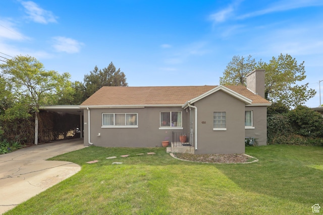 424 S 400 E, Orem, UT 84097 - back of property with stucco siding, a chimney, concrete driveway, a yard, and a carport