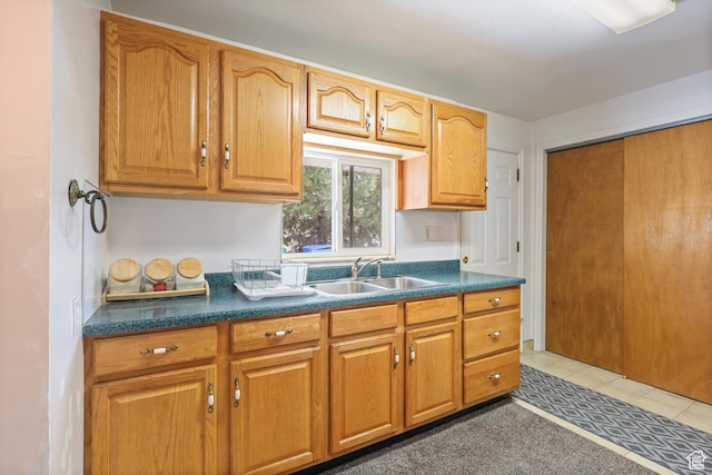 424 S 400 E, Orem, UT 84097 - kitchen featuring a sink, dark countertops, brown cabinetry, and light tile patterned flooring