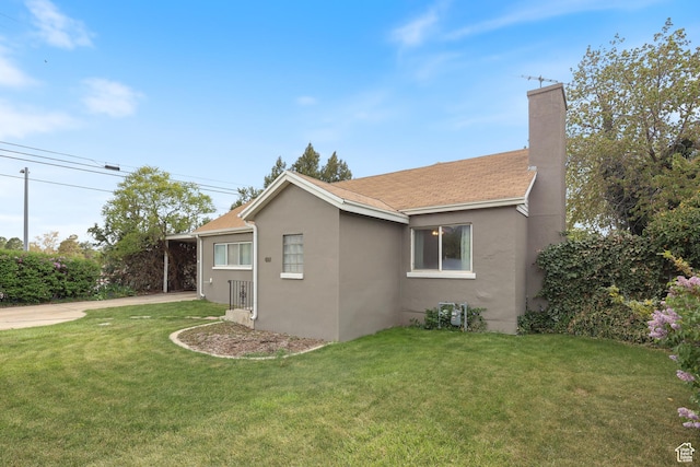 424 S 400 E, Orem, UT 84097 - view of home's exterior featuring driveway, a chimney, a lawn, stucco siding, and an attached carport