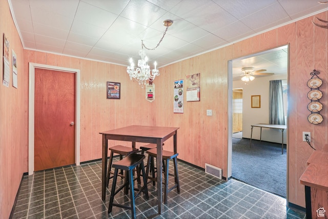 424 S 400 E, Orem, UT 84097 - dining room with visible vents, crown molding, wood walls, ceiling fan with notable chandelier, and dark floors
