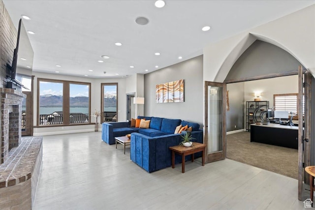 3630 S Panorama Dr W, Saratoga Springs, UT 84045 - living room featuring light wood-style floors, recessed lighting, plenty of natural light, and a brick fireplace