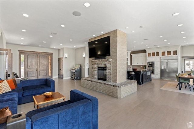 3630 S Panorama Dr W, Saratoga Springs, UT 84045 - living area featuring recessed lighting, a healthy amount of sunlight, light wood-style flooring, and a fireplace