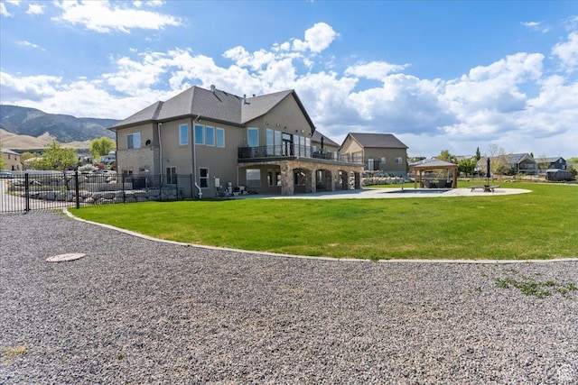 3630 S Panorama Dr W, Saratoga Springs, UT 84045 - rear view of property featuring a gazebo, stucco siding, fence, and a yard