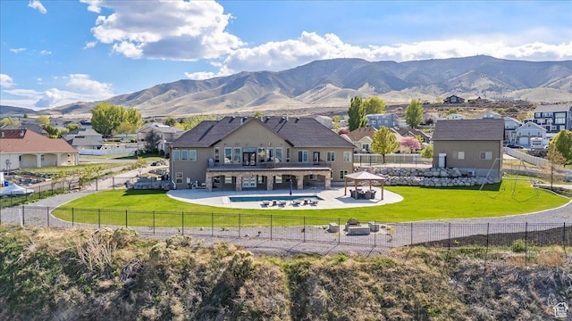 3630 S Panorama Dr W, Saratoga Springs, UT 84045 - rear view of property with a residential view, a fenced backyard, a mountain view, a patio area, and a lawn