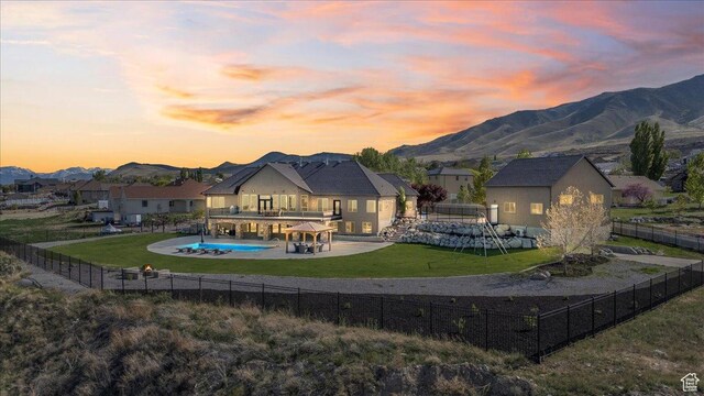 3630 S Panorama Dr W, Saratoga Springs, UT 84045 - back of property with a fenced in pool, a fenced backyard, a mountain view, a balcony, and a lawn