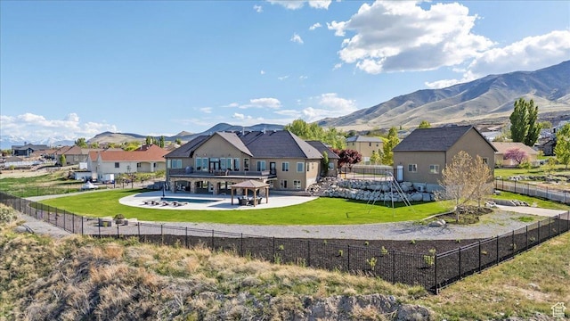 3630 S Panorama Dr W, Saratoga Springs, UT 84045 - back of house with a fenced backyard, a mountain view, a yard, and a patio area