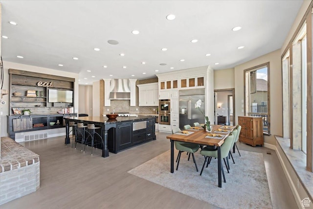 3630 S Panorama Dr W, Saratoga Springs, UT 84045 - dining area featuring recessed lighting, light wood finished floors, visible vents, and a fireplace