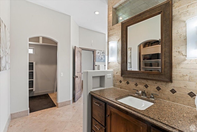 3630 S Panorama Dr W, Saratoga Springs, UT 84045 - full bath featuring vanity, baseboards, tile patterned floors, a spacious closet, and backsplash