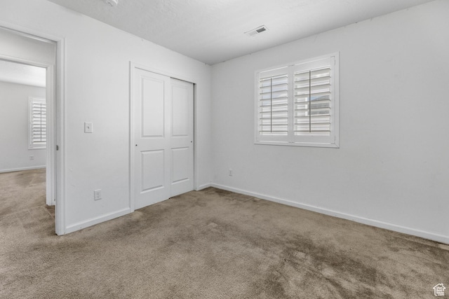 728 W Wild Hyacinth Dr, Saratoga Springs, UT 84045 - unfurnished bedroom with carpet floors, baseboards, visible vents, and a closet