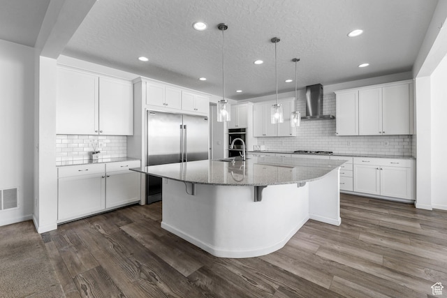 728 W Wild Hyacinth Dr, Saratoga Springs, UT 84045 - kitchen with recessed lighting, wall chimney exhaust hood, white cabinetry, and stainless steel appliances